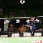 Workers prepare food at a traditional roadside dhaba restaurant; as such eateries continue to serve affordable meals to residents and labourers across the city