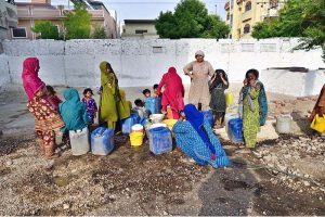 A large number of women filling their pots with water from water tap at Husenabd area
