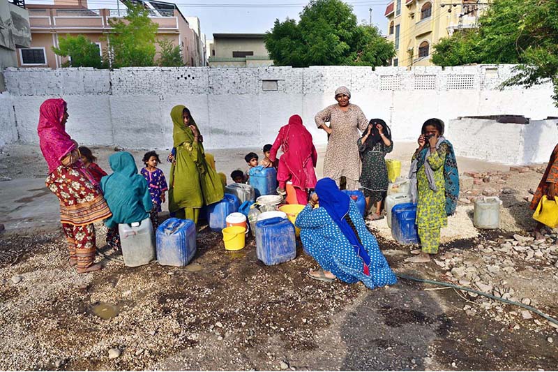 A large number of women filling their pots with water from water tap at Husenabd area