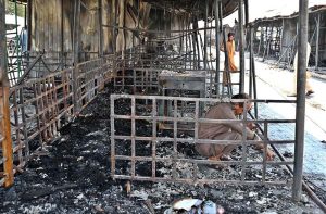 Vendors gather their salvaged goods amid the aftermath of a devastating fire that swept through the weekly H-9 Bazaar near Peshawar Mor in the Federal Capital, leaving numerous shops damaged and traders counting their losses.