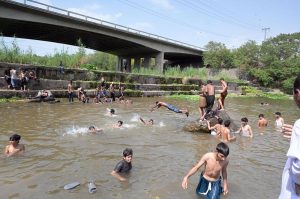 A large number of youngsters swim and splash in the Rawal Lake spillway waters to seek relief from the intense summer heat in the federal capital. The spillway has become a popular spot for young citizens looking to cool off as temperatures soar across Islamabad during the ongoing heat wave season
