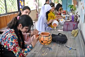 Students show their painting skills on pottery at a stall during the Summer School & Fiesta 2026 at Islamabad College for Girls, F-6/2