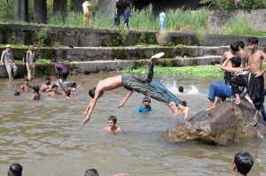 A large number of youngsters swim and splash in the Rawal Lake spillway waters to seek relief from the intense summer heat in the federal capital. The spillway has become a popular spot for young citizens looking to cool off as temperatures soar across Islamabad during the ongoing heat wave season