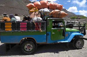 A driver is busy washing his vehicle with stream water in Upper Chitral.