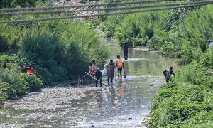 CDA workers clean a drainage channel along the Islamabad Expressway as part of ongoing efforts to improve sanitation and ensure smooth water flow for the monsoon season in the federal capital.
