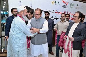 Minister of State for Development and Planning Chaudhry Armaghan Subhani, Chairman Sial Hassan Ali Bhatti welcomes the first and second flight pilgrims returning from Saudi Arabia at the Sialkot International Airport