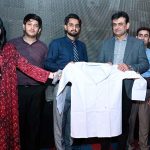 Deputy Commissioner Tariq Manzoor Chandio distributes ceremonial white coats to newly admitted DPT and BS Nursing students during the Orientation and White Coat Ceremony at Chandka Institute of Nursing and Allied Health Sciences