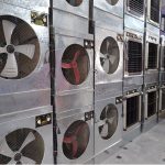 A worker arranges room air coolers on display for sale at a shop in tarlai area, as demand for cooling appliances rises amid the ongoing summer heatwave