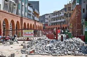 Construction work is underway at Commercial Market as workers lay paving tiles on the main road as part of the Traffic-Free Street project.