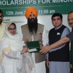Provincial Minister for Minority Affairs Sardar Ramesh Singh Arora distributes educational scholarship cheques among students from minority communities during a ceremony held at the Divisional Model College (DMC) Hall