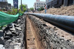 Deep Excavation Underway as workers install large water supply pipelines using heavey machinery on Saidpur Road.