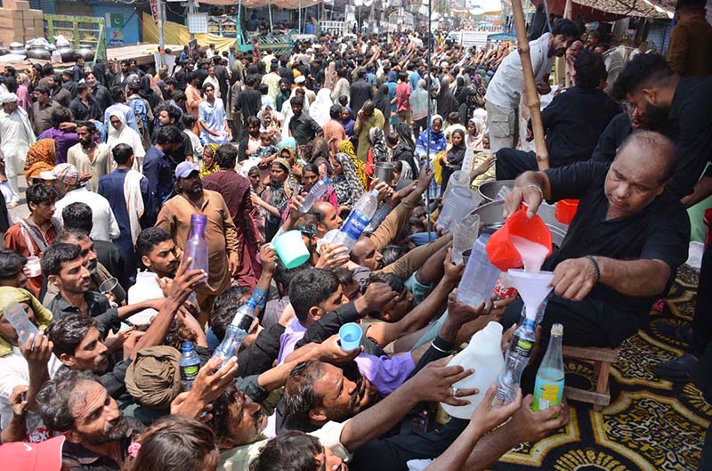 Volunteers serving drinks to mourners attending the Ashura procession on 10th of Muharramul Harram near Clock Tower Chowk. Muharram is the mourning month in remembrance of the Shahadat of Hazrat Imam Hussain (RA), the grandson of the Holy Prophet Mohammad (PBUH)