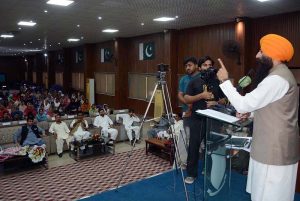Provincial Minister for Minority Affairs Sardar Ramesh Singh Arora distributes educational scholarship cheques among students from minority communities during a ceremony held at the Divisional Model College (DMC) Hall