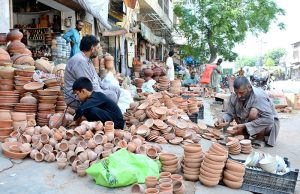 An artisan is busy preparing traditional oven (tandor) at Railway Road.