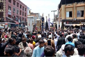 Volunteers serving drinks to mourners attending the Ashura procession on 10th of Muharramul Harram near Clock Tower Chowk. Muharram is the mourning month in remembrance of the Shahadat of Hazrat Imam Hussain (RA), the grandson of the Holy Prophet Mohammad (PBUH)