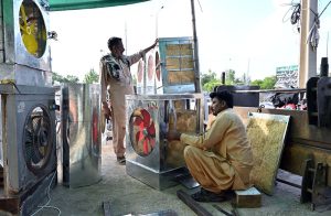 A skilled worker making room air coolers at his local workshop in the City.