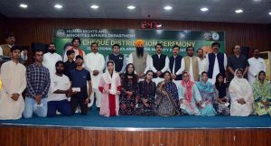 Provincial Minister for Minority Affairs Sardar Ramesh Singh Arora distributes educational scholarship cheques among students from minority communities during a ceremony held at the Divisional Model College (DMC) Hall