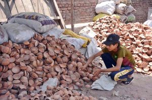 A vendor displays clay pots that traditionally used for distributing food during Muharram-ul-Haram.