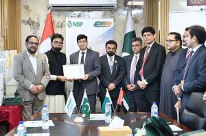 Consul General H.E. Hussain Muhammad, accompanied by Rashid-ul-Islam, Asad Malik, Muhammad Shabbir Merchant, Saleem Akhtar, Khalid Hussain Chaudhry, Majid Rafiq, Mohammad Shoaib and officers of the Consulate General of Pakistan, Dubai, poses with distinguished guests during the International Day of Family Remittances ceremony organized in collaboration with NBP UAE