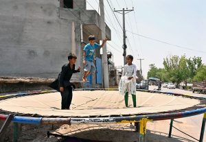 Children enjoy jumping on a bouncing trampoline at Fazil Town.