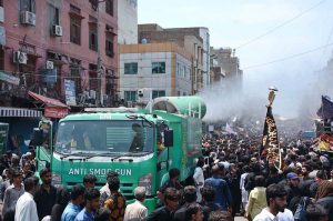 Volunteers serving drinks to mourners attending the Ashura procession on 10th of Muharramul Harram near Clock Tower Chowk. Muharram is the mourning month in remembrance of the Shahadat of Hazrat Imam Hussain (RA), the grandson of the Holy Prophet Mohammad (PBUH)
