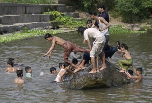 People swim at the Rawal Dam spillway in Chak Shahzad to beat the scorching heat as the mercury soars to around 46°C, with the ongoing heatwave driving residents to seek relief from the extreme temperatures in the federal capital.