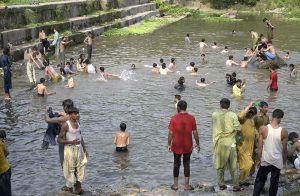 People swim at the Rawal Dam spillway in Chak Shahzad to beat the scorching heat as the mercury soars to around 46°C, with the ongoing heatwave driving residents to seek relief from the extreme temperatures in the federal capital.