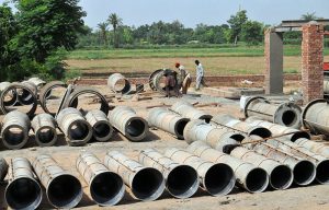 Labourers are busy preparing cement sewerage pipes at their workplace as development work continues to improve the city's drainage and sanitation infrastructure.