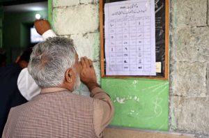 Election officials process ballot papers and verify voter credentials at a polling station during the Gilgit-Baltistan General Elections 2026.
