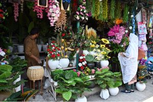 A vendor arranges a variety of dry fruits, including dates, raisins and nuts, on display at his shop weekly bazaar at Peshawar Mor, H-9 in the Federal Capital