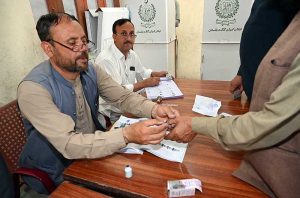 Election officials process ballot papers and verify voter credentials at a polling station during the Gilgit-Baltistan General Elections 2026.