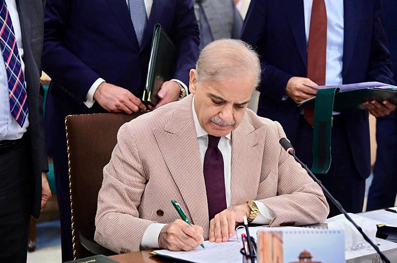 Prime Minister Muhammad Shehbaz Sharif signing Annual Budget 2026-27 documents after its approval by the Federal Cabinet meeting at Parliament House