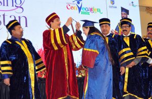 Chairman Senate of Pakistan Syed Yousaf Raza Gillani awards a distinction-holding graduate during the Annual Convocation 2026 of the College of Tourism and Hotel Management (COTHM) at a local hall.