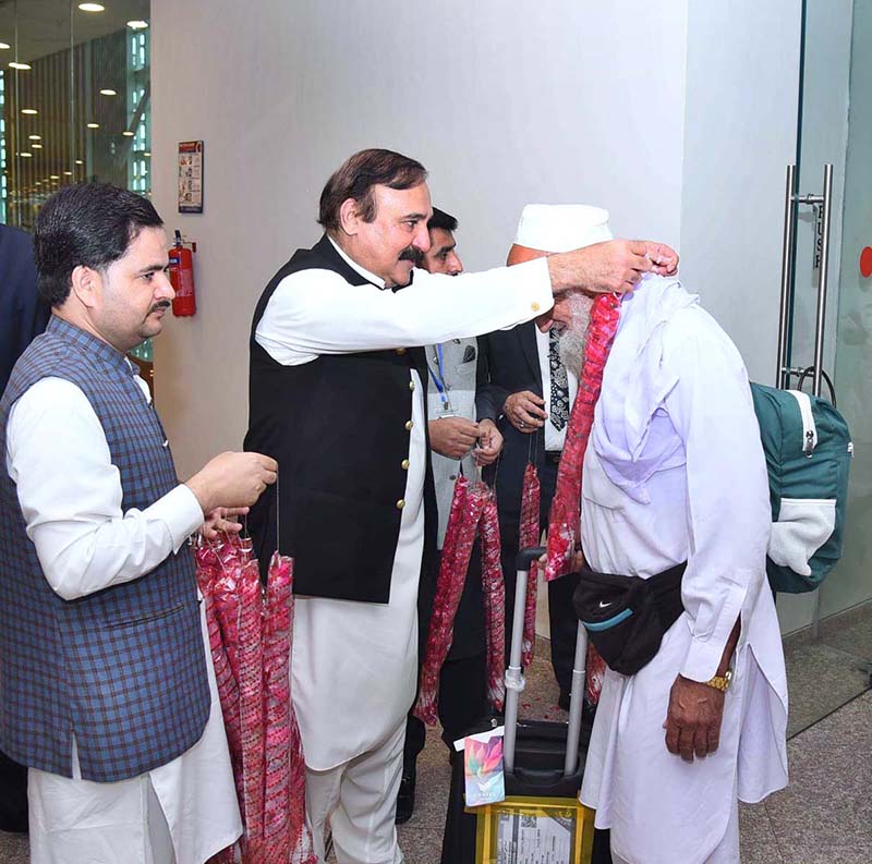 Federal Minister for Parliamentary Affairs Dr. Tariq Fazal Chaudhry welcomes Hajj pilgrims returning from Saudi Arabia at Islamabad Airport