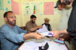 Election officials process ballot papers and verify voter credentials at a polling station during the Gilgit-Baltistan General Elections 2026.