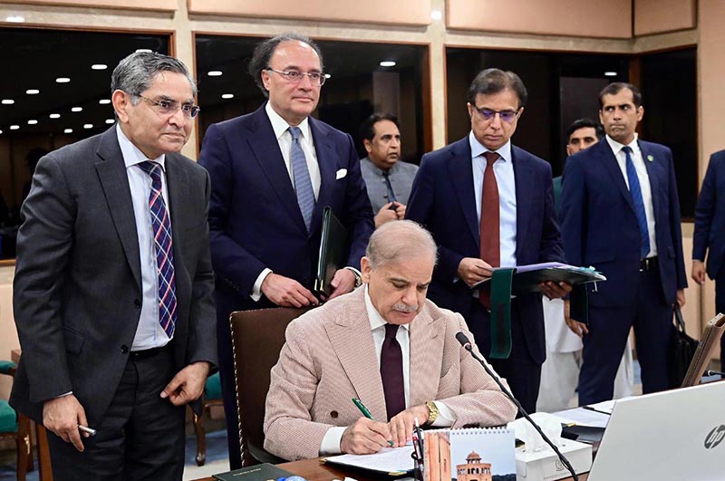 Prime Minister Muhammad Shehbaz Sharif signing Annual Budget 2026-27 documents after its approval by the Federal Cabinet meeting at Parliament House