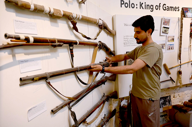 Visitor taking interest in display items at the Heritage Museum