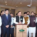 Federal Minister for Parliamentary Affairs Dr. Tariq Fazal Chaudhry speaks to the media at Islamabad Airport after welcoming Hajj pilgrims