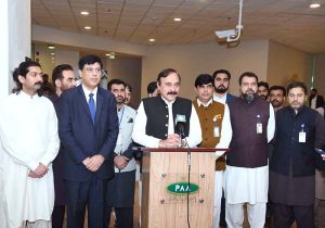 Federal Minister for Parliamentary Affairs Dr. Tariq Fazal Chaudhry speaks to the media at Islamabad Airport after welcoming Hajj pilgrims