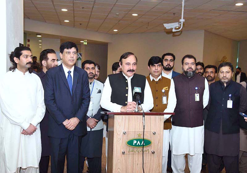 Federal Minister for Parliamentary Affairs Dr. Tariq Fazal Chaudhry speaks to the media at Islamabad Airport after welcoming Hajj pilgrims