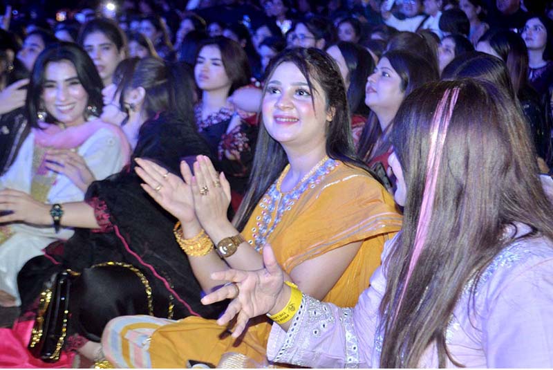 Women enjoy themselves while renowned singer Rahat Fateh Ali Khan performs songs and Qawwali during a night of music at a local hotel late Sunday night