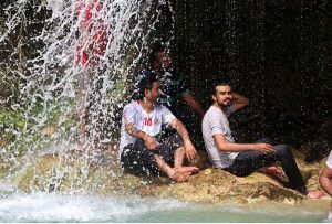 A man enjoy bathing to get relief from scorching hot weather in City.