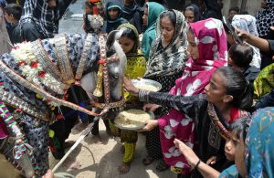 Mourning participants offer Niaz to Zuljinah during a procession on the 6th of Muharram-ul-Haram at Hussainabad.