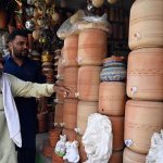 A vendor displays clay water coolers for sale on Ferozepur Road as many people continue the traditional practice of drinking water from earthen pots