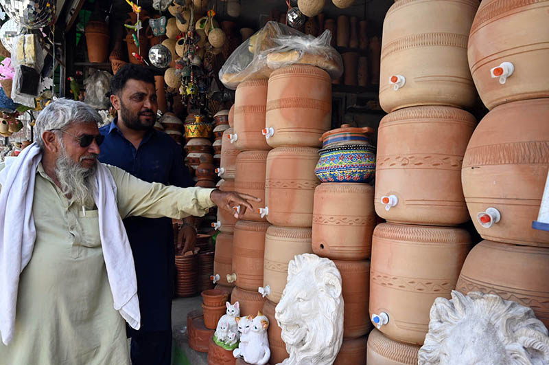 A vendor displays clay water coolers for sale on Ferozepur Road as many people continue the traditional practice of drinking water from earthen pots