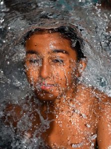 A youngster dives into a swimming pool to get relief from the scorching summer heat in the city.