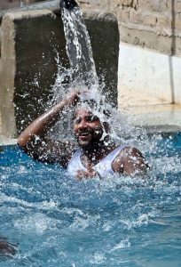A youngster dives into a swimming pool to get relief from the scorching summer heat in the city.