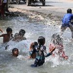 Children enjoying bath in a canal at Muradabad