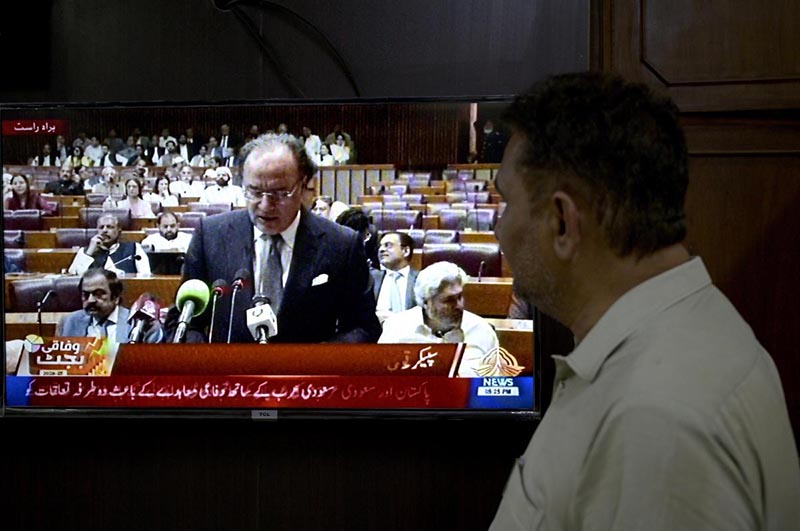 A citizen's eyes are fixed on the screen on the budget speech of Finance Minister Muhammad Aurangzeb as he presents the Federal Budget 2026-27 in the National Assembly at Parliament House, reflecting the widespread public interest in the country's economic direction and fiscal policies