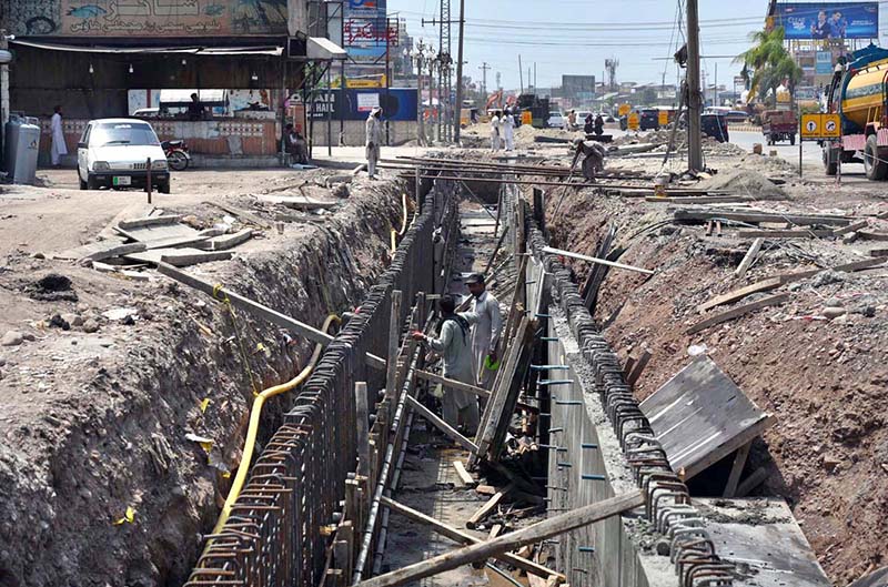Laborers on work during the construction work of the underpass at Kabutar Chowk, Ring Road